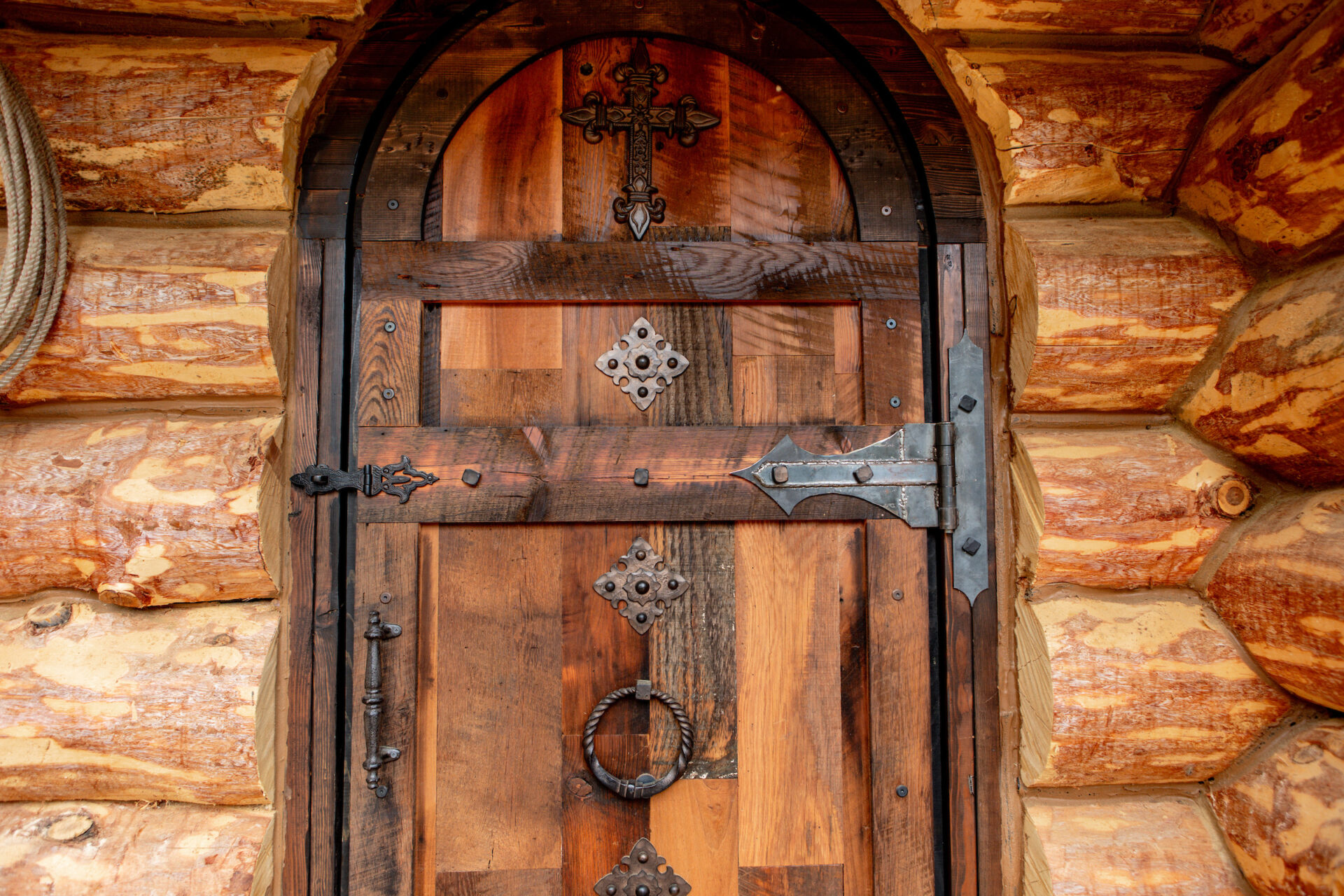 Champagne Leather & Wood A wooden door in a log cabin.